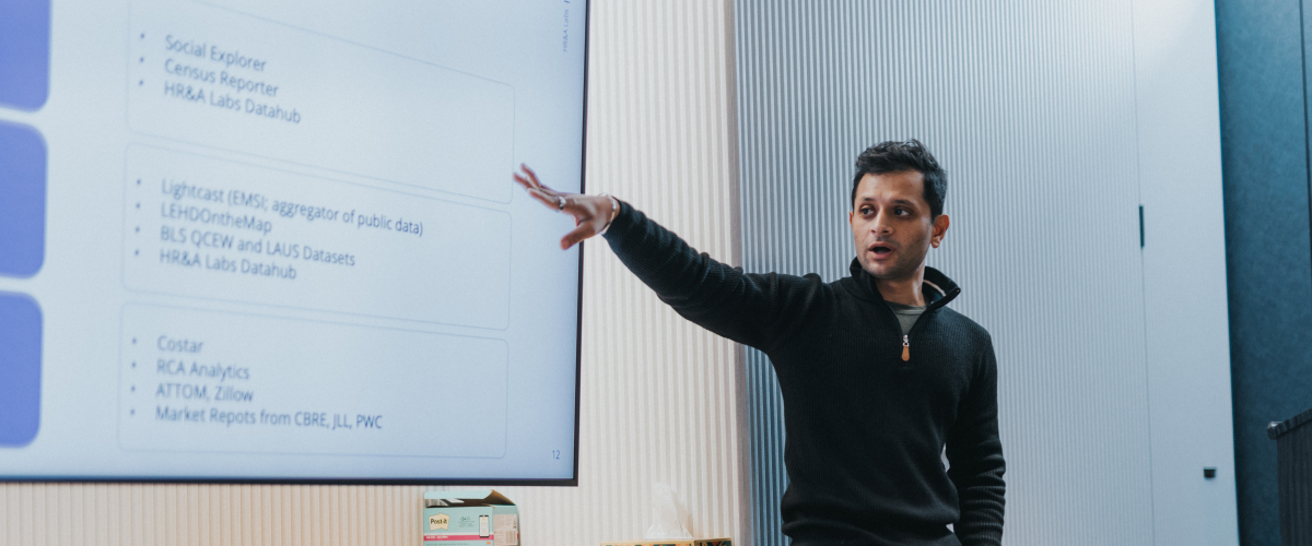 A man gestures to a computer screen.